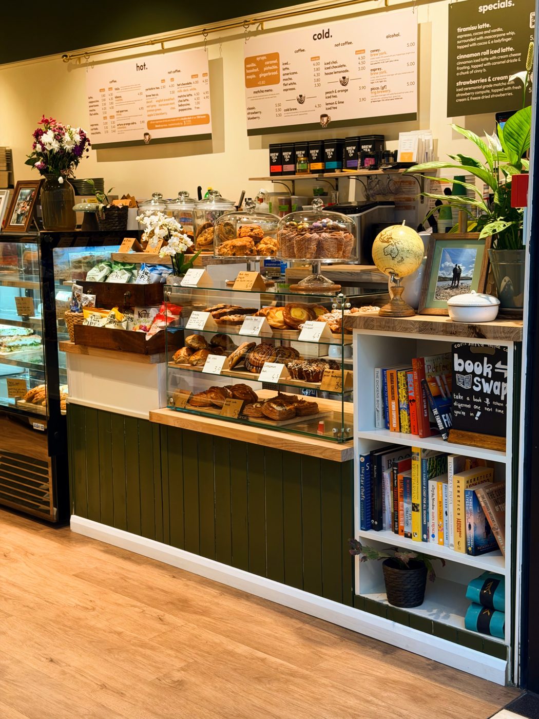 Inside the brew'd shop, the counter, pastry case and menu boards