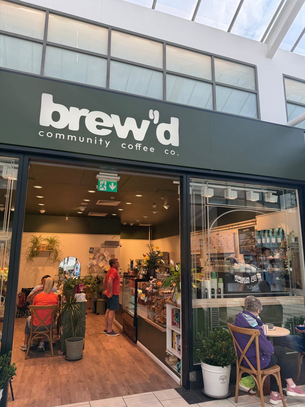 The brew'd shopfront at Designer Outlet York, green fascia with the cream wordmark